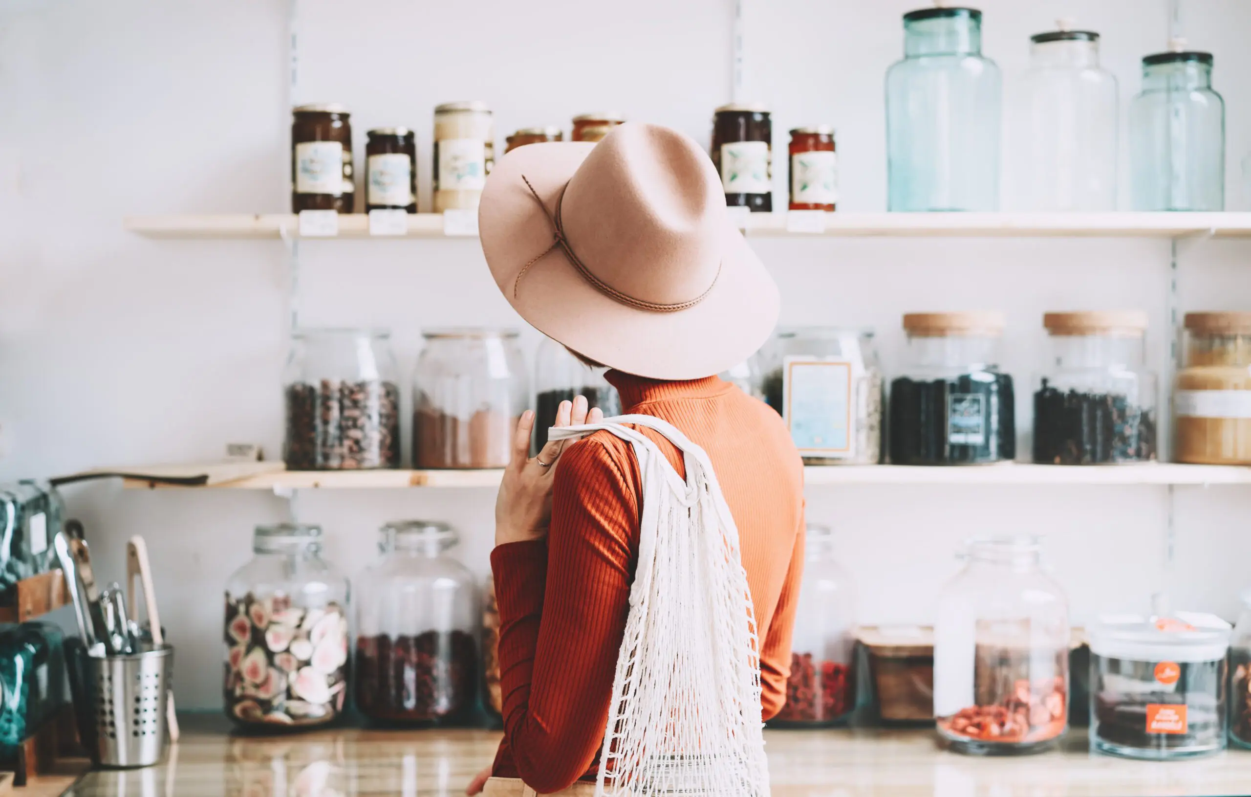 Young woman in zero waste shop or plastic free store.