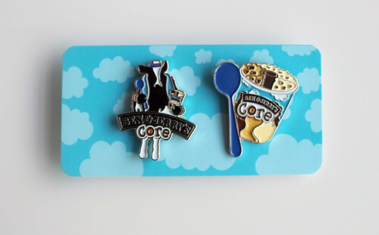 Ben and Jerry's enamel pins depicting a cop and a container of icecream
