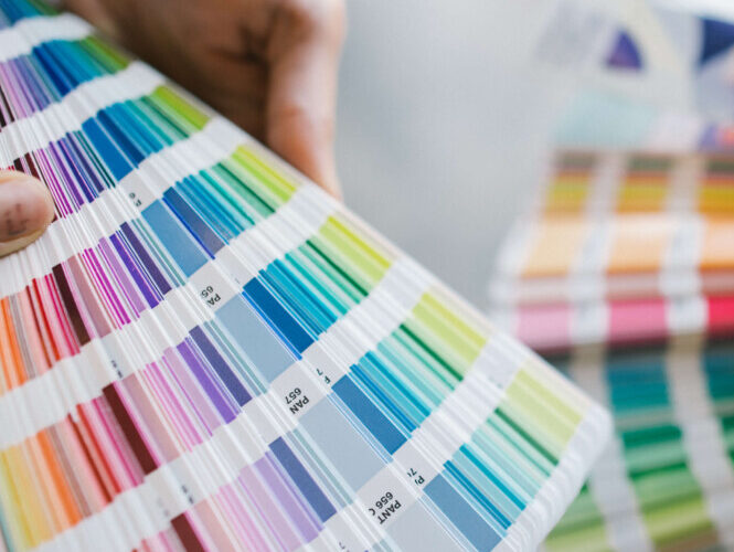 Pantone books fanned out showing all of their colours