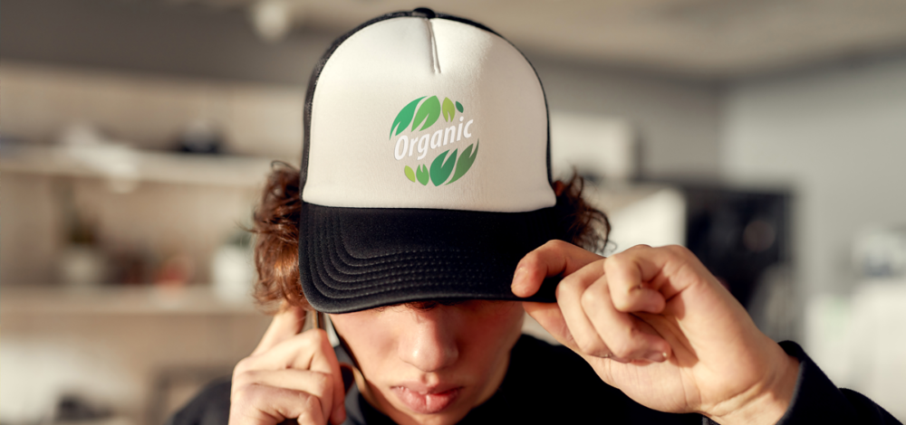 person wearing a hat labeled organic