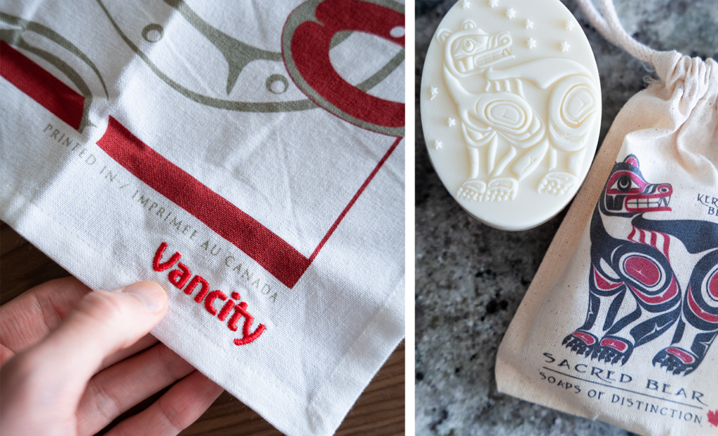2 Images: The first is a person holding a Vancity branded tea towel with a indigenous art in a red design. The second is an indigenous artwork design carved in to a bar of soap beside a small canvas bag with the same design. 