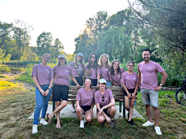 The Fairware team in a park, wearing purple t shirts
