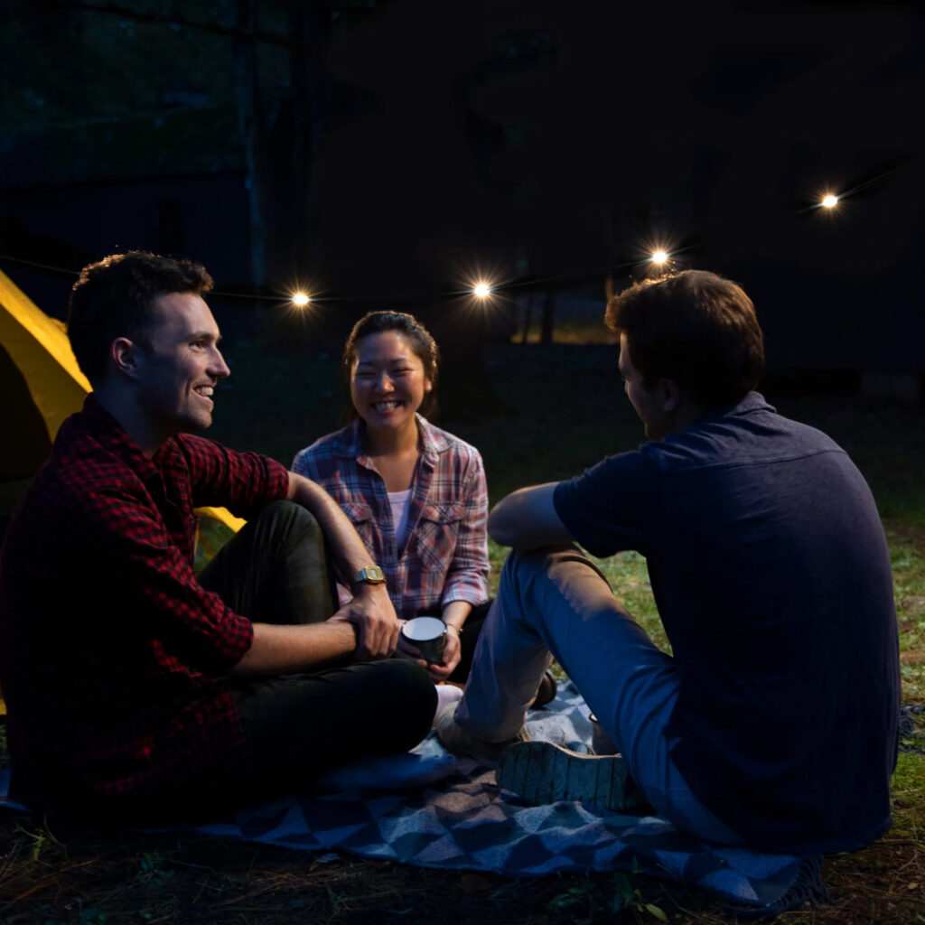 string solar lights with people sitting in front of a tent