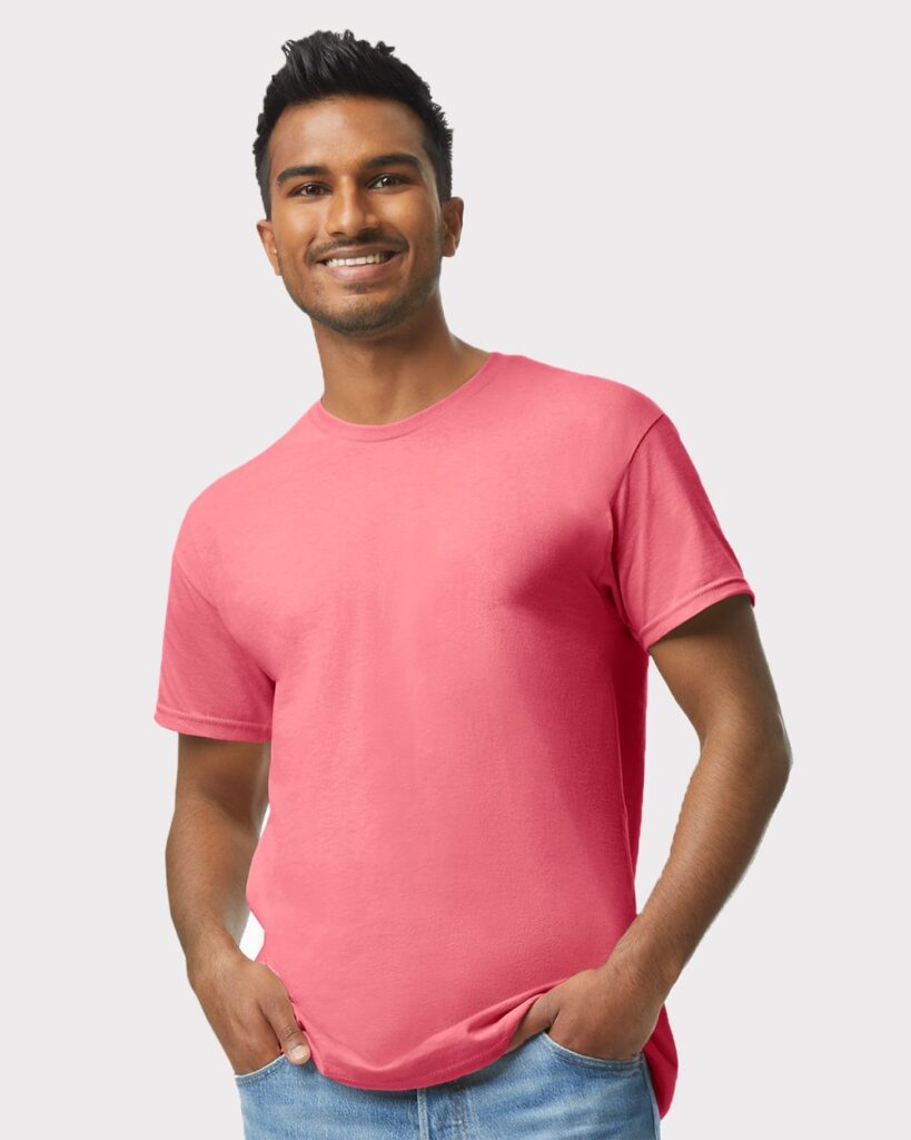 man on white background smiling wearing a red tshirt.