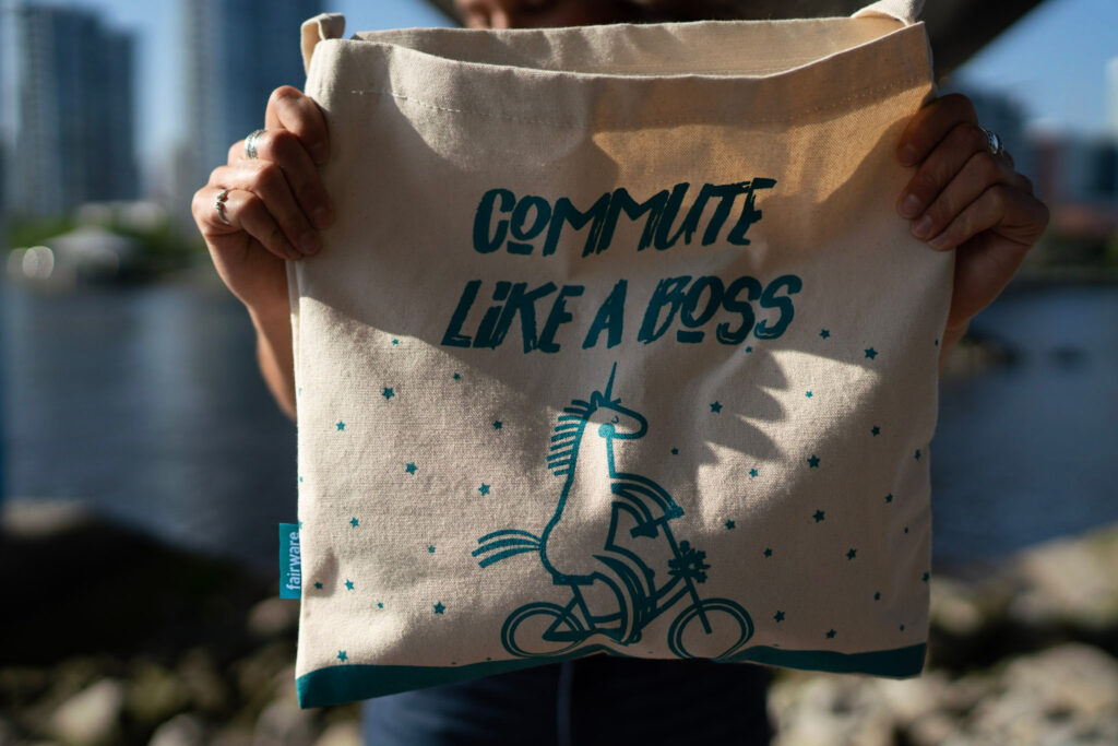 tote bag that reads commute like a boss with an image of a unicorn on a bike.