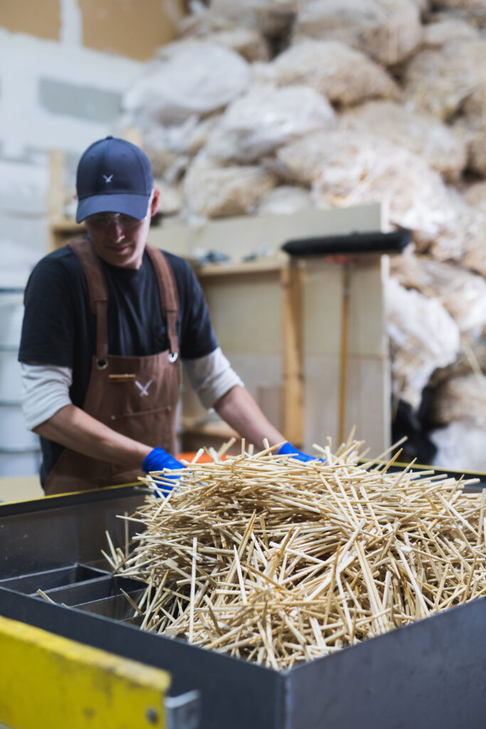 worker with chopsticks in a bin