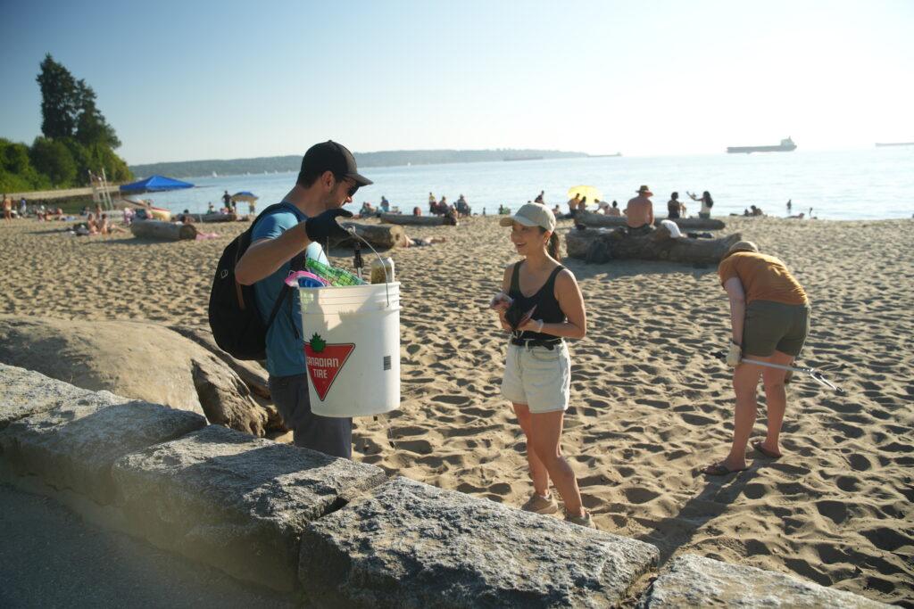 people picking up trash from the beach