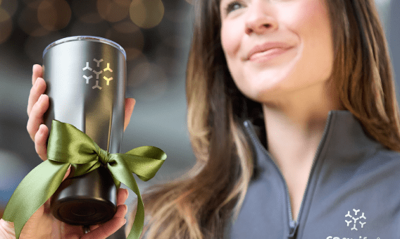 woman being gifted drinkware in a branded shirt