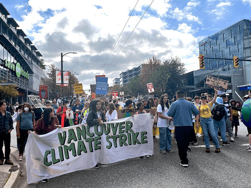 2024 climate strike - people walk along cambie street