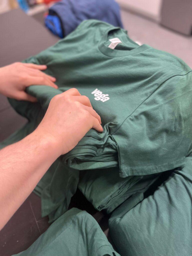 vega tshirts being folded